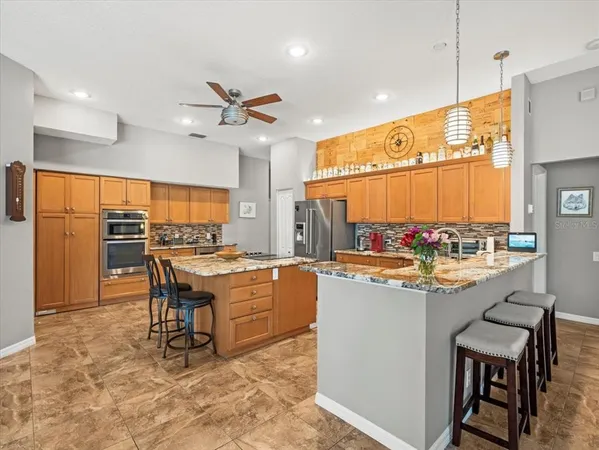 a kitchen with stainless steel appliances granite countertop a stove oven and a refrigerator