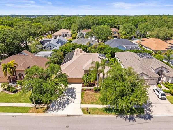 a view of a house with a tree and a yard