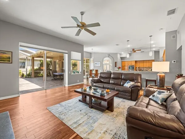 an empty room with a fan & a ceiling fan
