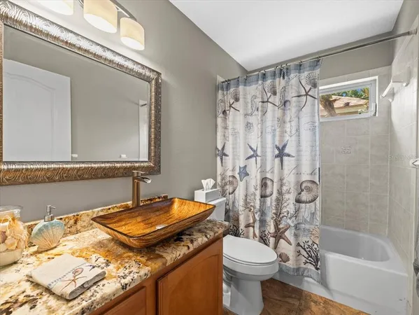 a view of a porch with furniture and a yard