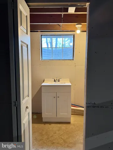 a front view of a house with a yard and large trees