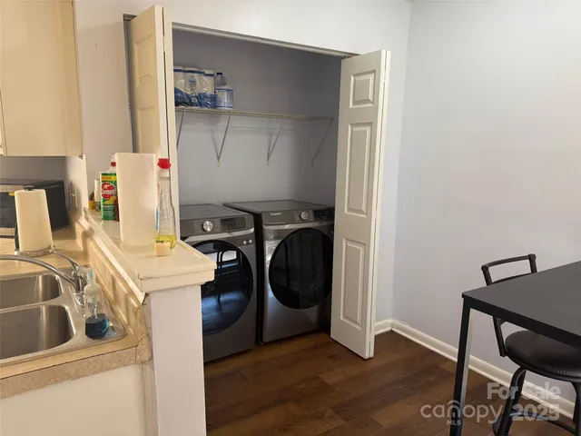a view of a room with furniture wooden floor and a table