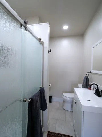 a bathroom with a sink toilet tub and shower