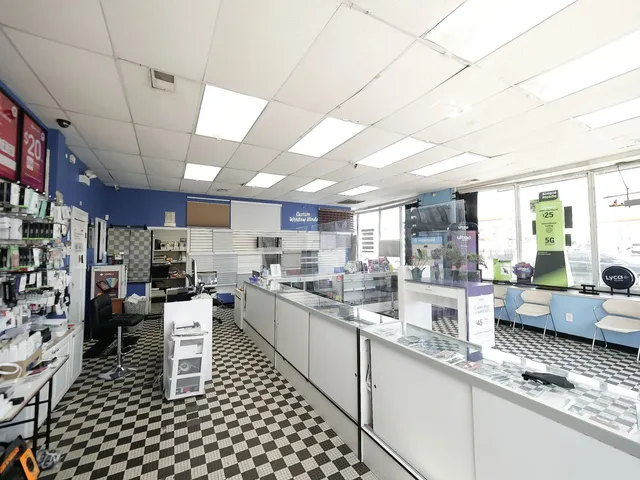 a view of a hallway with stainless steel appliances