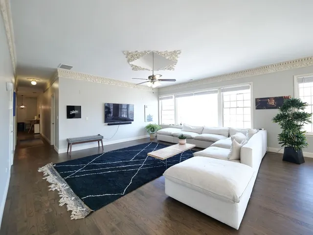 a living room with furniture and wooden floor