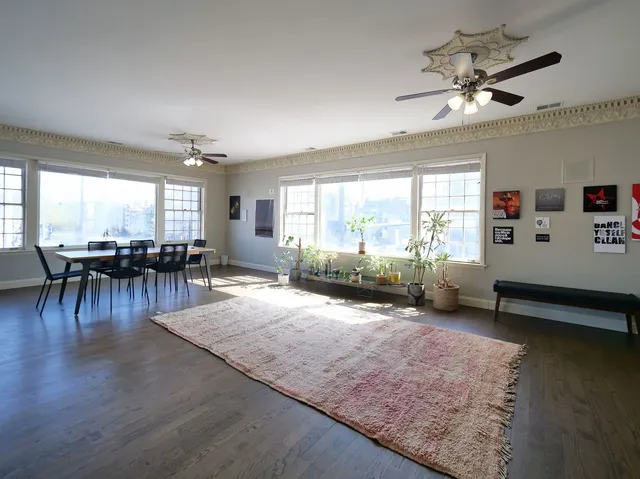 a living room with couch tv and a large window