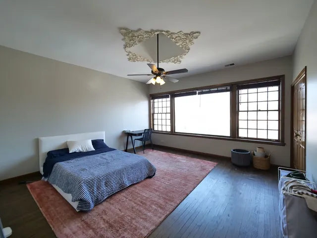 a bedroom with a bed dresser and a window
