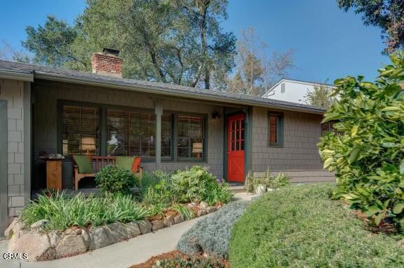 a front view of a house with garden