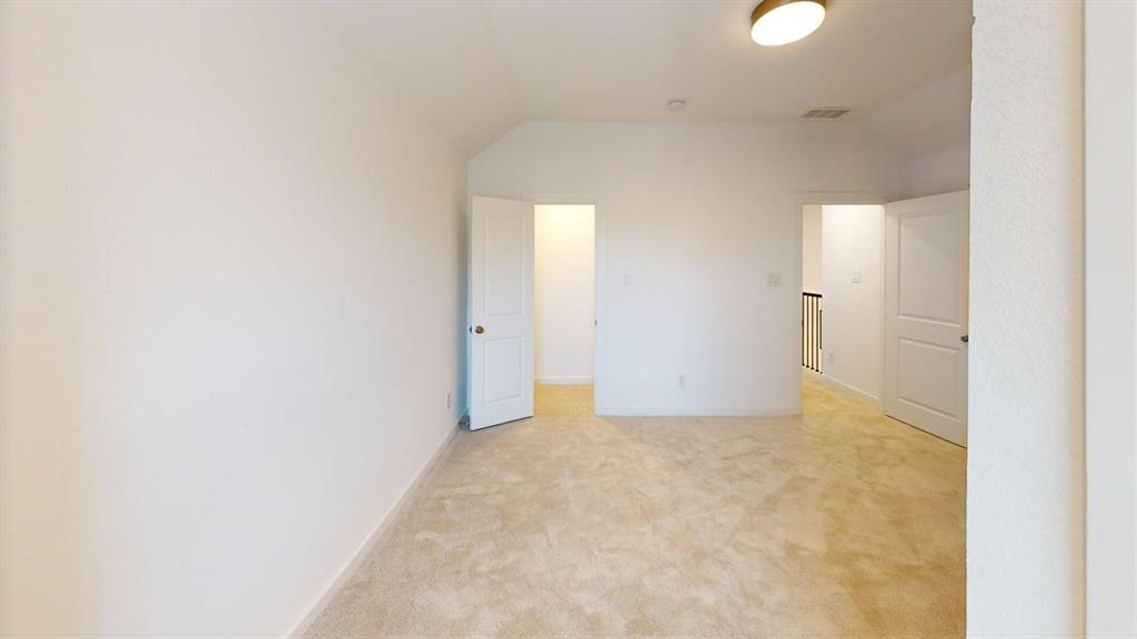 9628 Boulder Pt Road Oak Point, TX 75068 - Photo 12 of 35 Carpeted room with white walls, a single flush-mount ceiling light fixture, and multiple doorways featuring white panel doors
