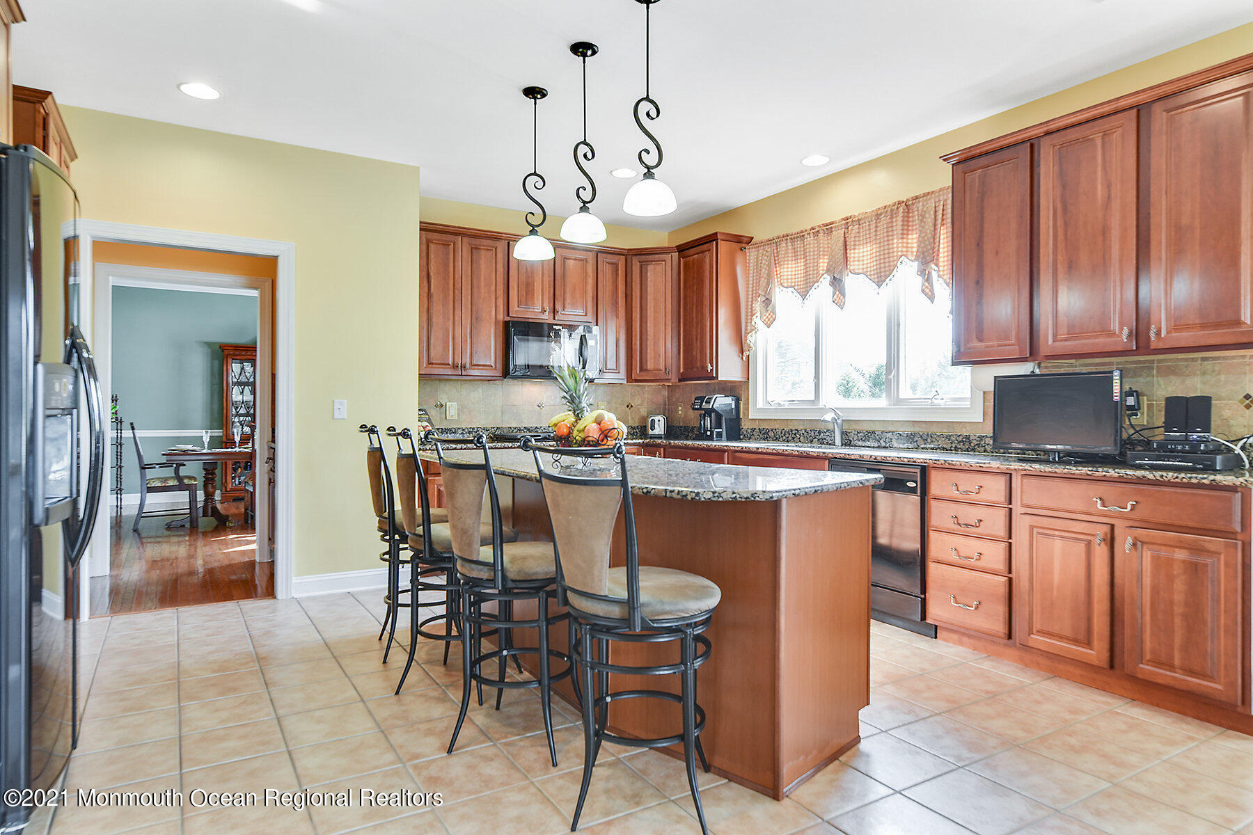 3 Great Bridge Road Freehold, NJ 07728 - Photo 8 of 40 a kitchen with granite countertop a table chairs microwave and cabinets