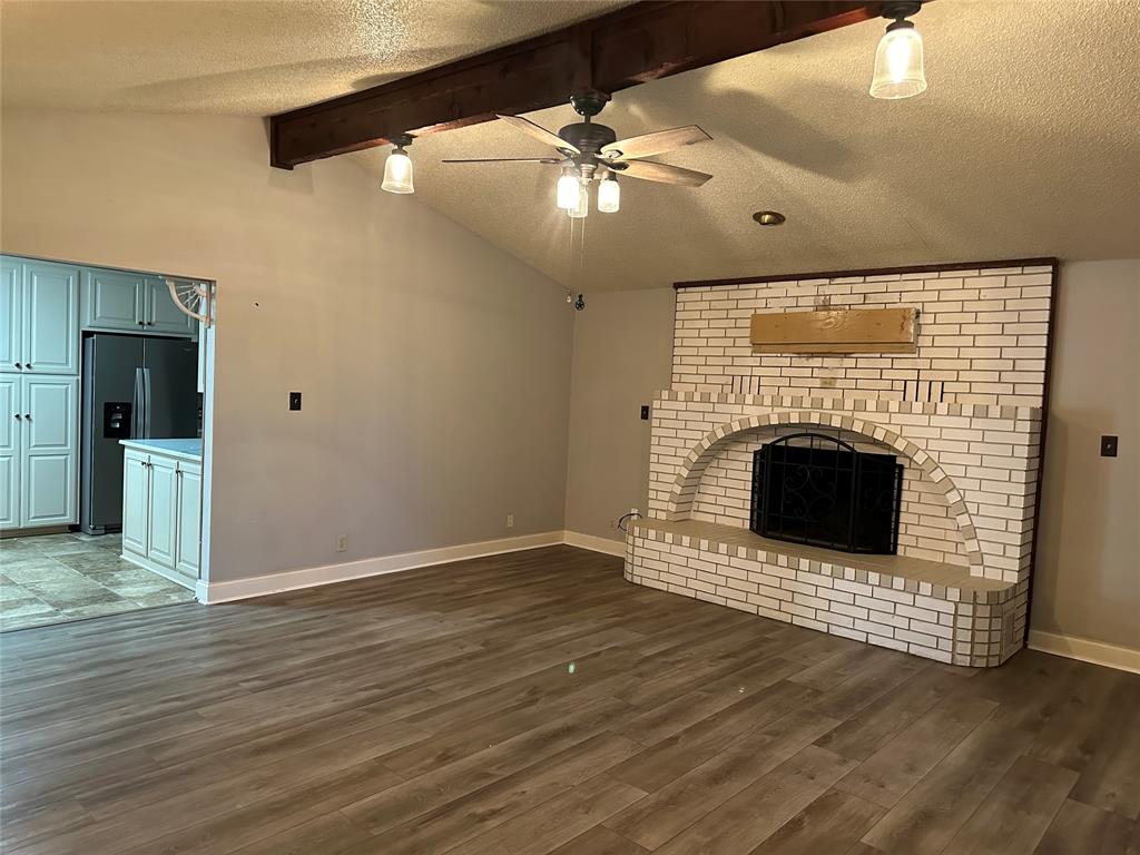 137 Oakview Circle Waco, TX 76705 - Photo 17 of 35 an empty room with wooden floor a fireplace
