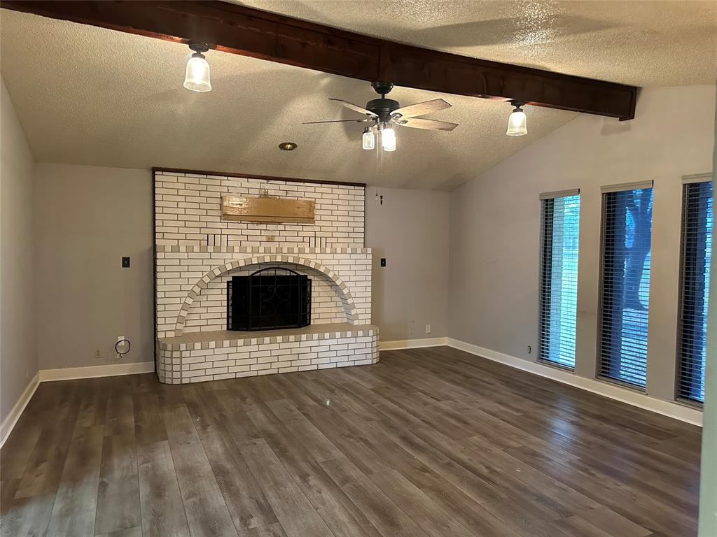 137 Oakview Circle Waco, TX 76705 - Photo 18 of 35 wooden floor in an empty room with a fireplace