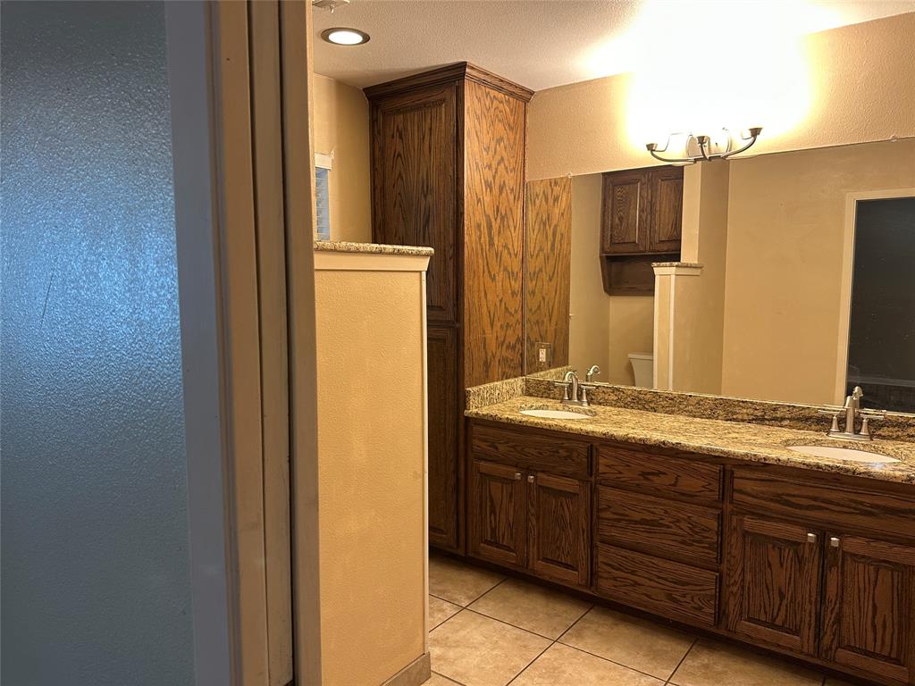 137 Oakview Circle Waco, TX 76705 - Photo 23 of 35 a bathroom with a granite countertop sink and a mirror