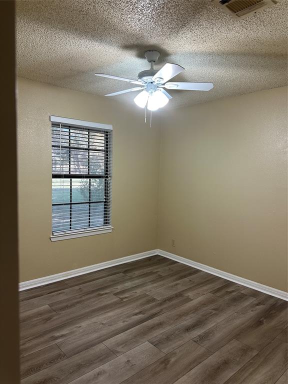 137 Oakview Circle Waco, TX 76705 - Photo 26 of 35 a view of an empty room with wooden floor and a window