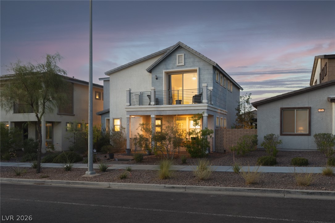 920 East Sunset Road Henderson, NV 89011 - Photo 1 of 33 Modern two-story home with a second-story balcony, offering a serene outdoor retreat.