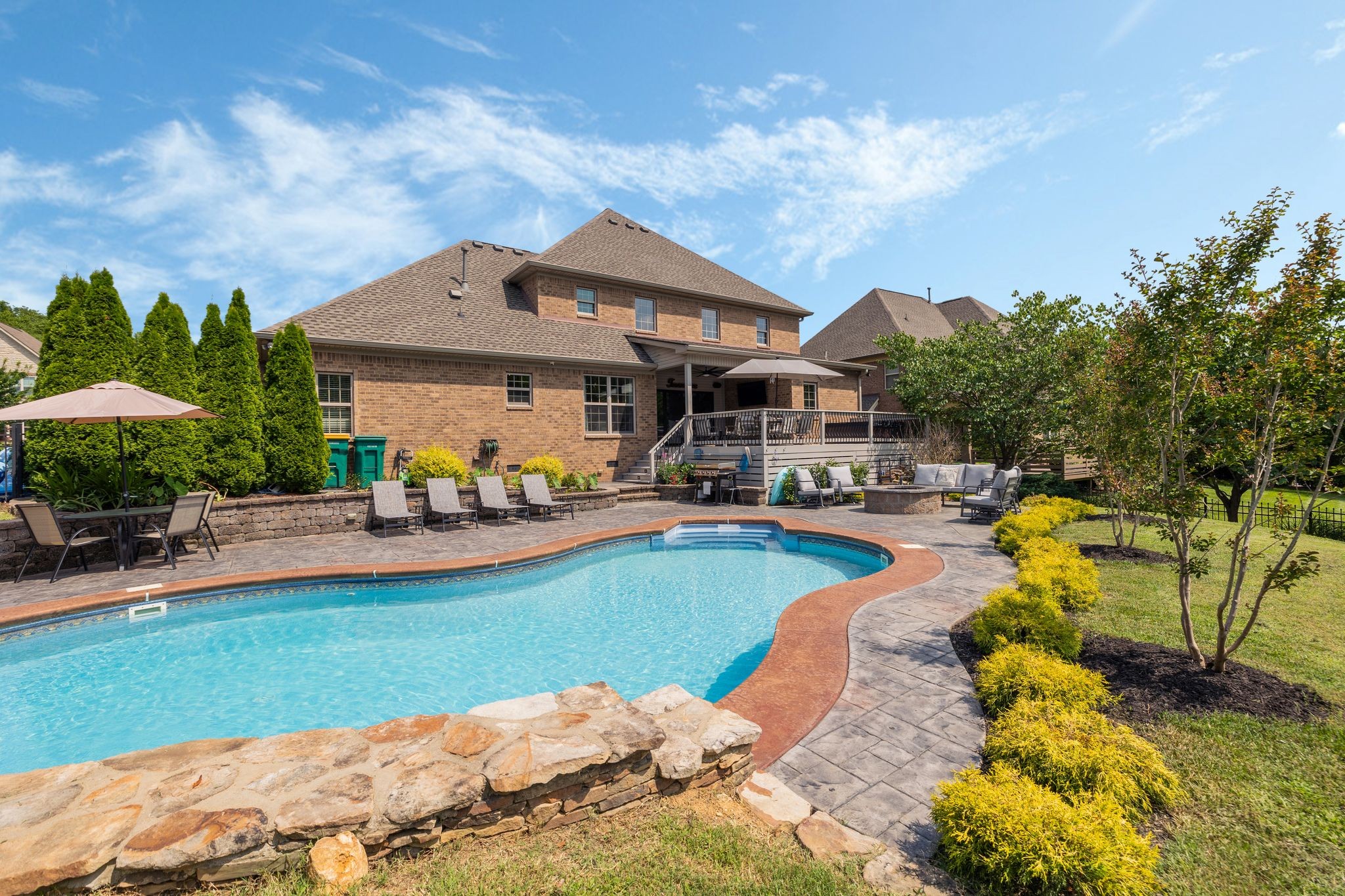 a swimming pool with outdoor seating and yard