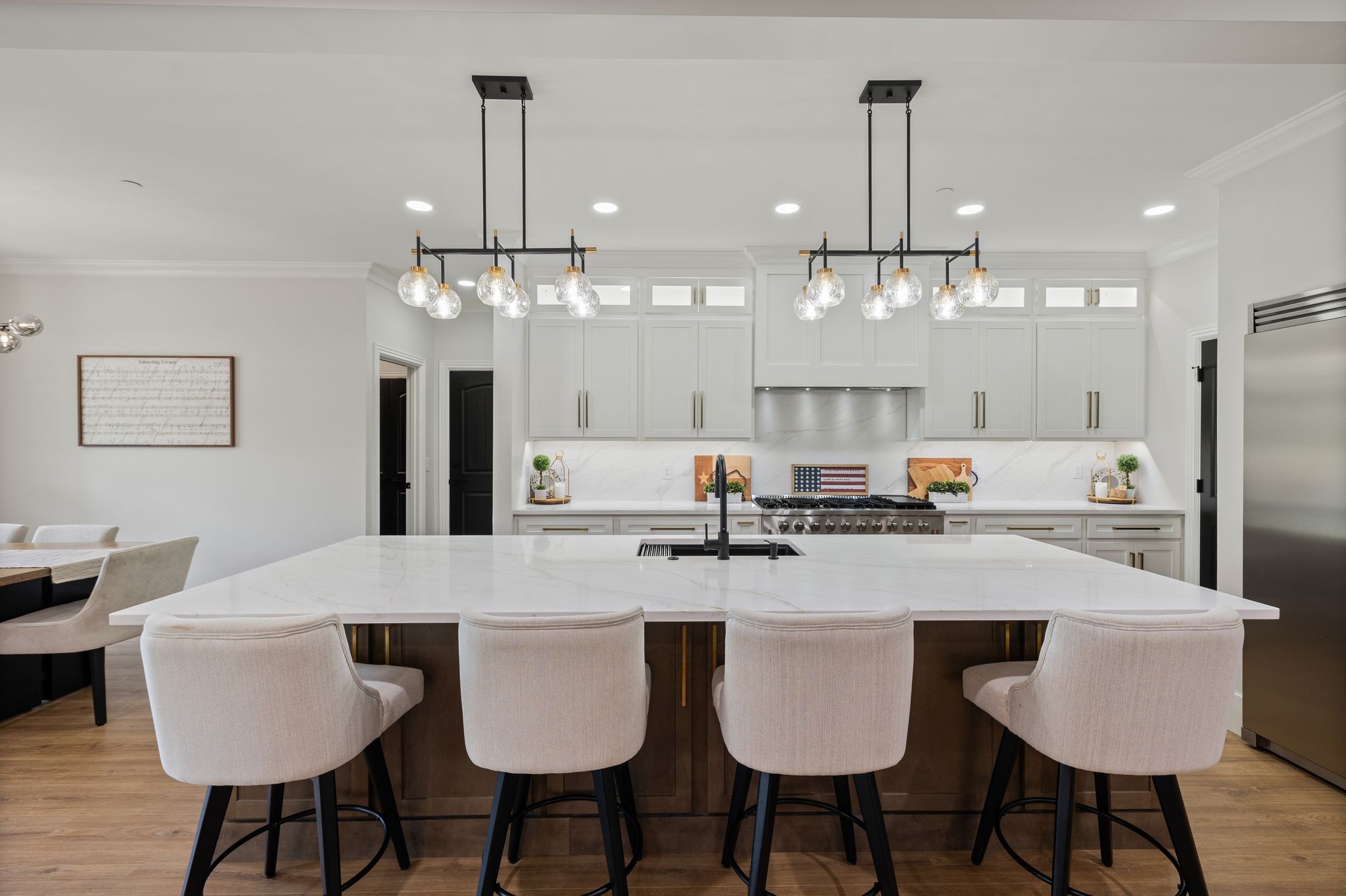 4024 Campania Strada Spring Hill, TN 37174 - Photo 16 of 53 a kitchen with stainless steel appliances granite countertop a dining table chairs and chandelier