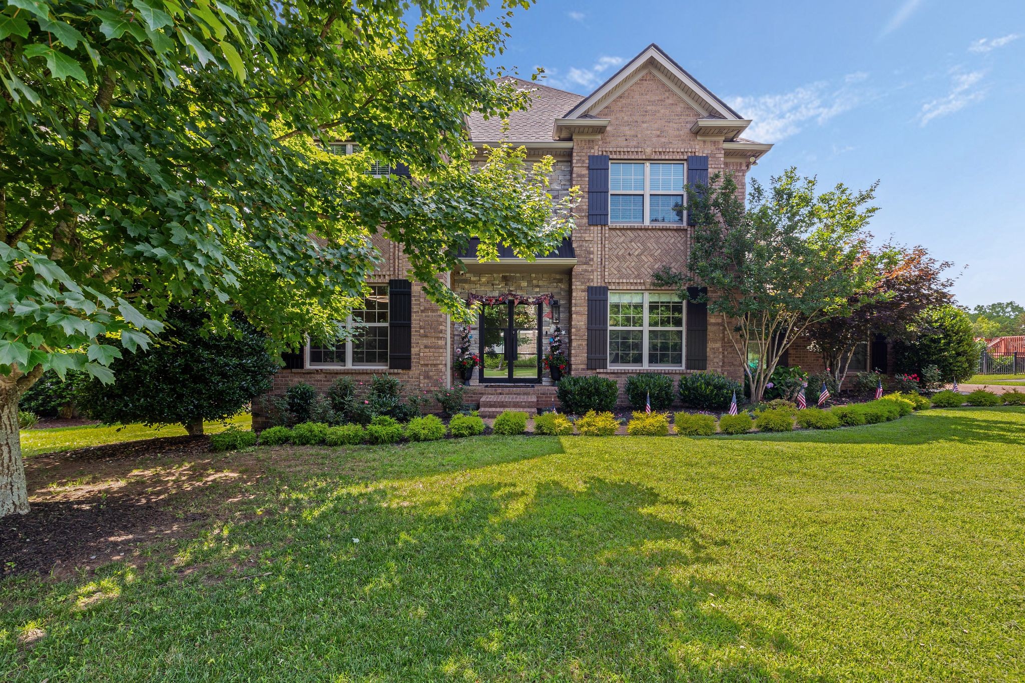 4024 Campania Strada Spring Hill, TN 37174 - Photo 4 of 53 a front view of a house with garden and trees