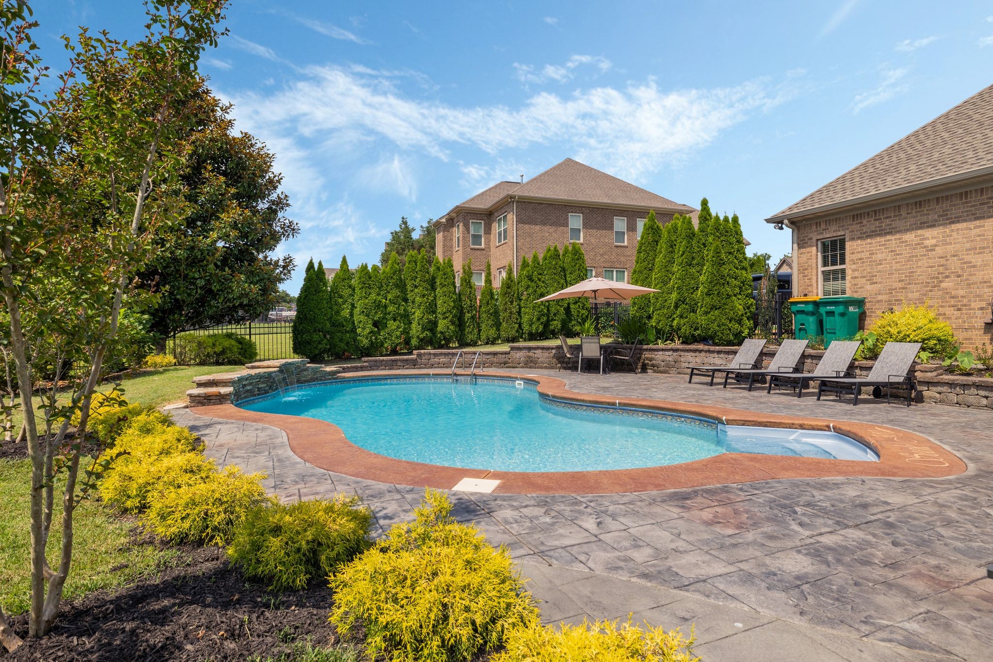 4024 Campania Strada Spring Hill, TN 37174 - Photo 53 of 53 a view of a swimming pool with lawn chairs under an umbrella