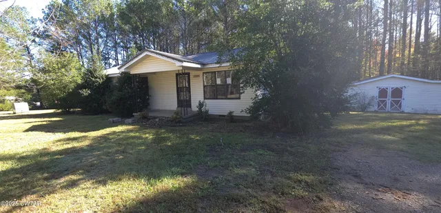 a backyard of a house with yard and outdoor seating