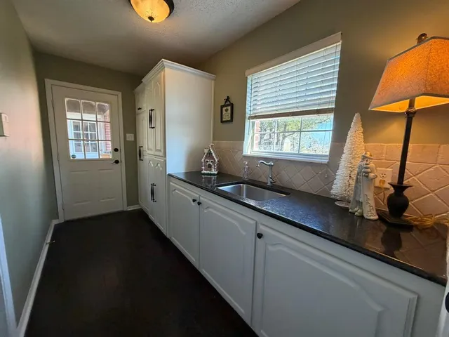 a kitchen with sink and window