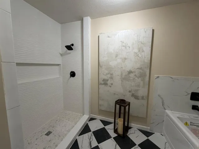 a bathroom with a sink a toilet a shower and mirror