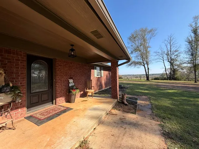 a view of a house with backyard porch and sitting area