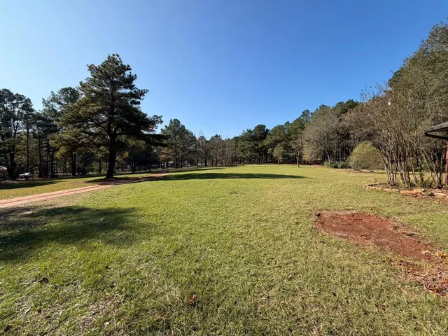 a view of outdoor space with swimming pool and green space