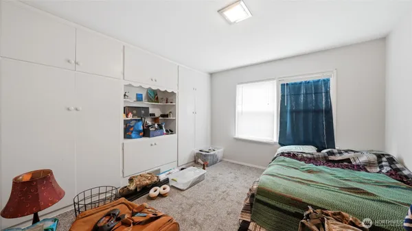 a bedroom with bed and a window