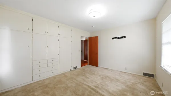 a room with a window and a desk