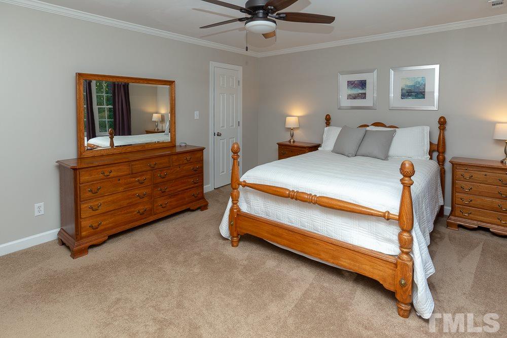 5909 North Hawthorne Way Raleigh, NC 27613 - Photo 14 of 25 a bedroom with bed and window