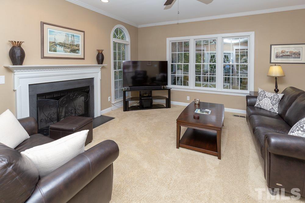 5909 North Hawthorne Way Raleigh, NC 27613 - Photo 3 of 25 a living room with furniture window and a flat screen tv