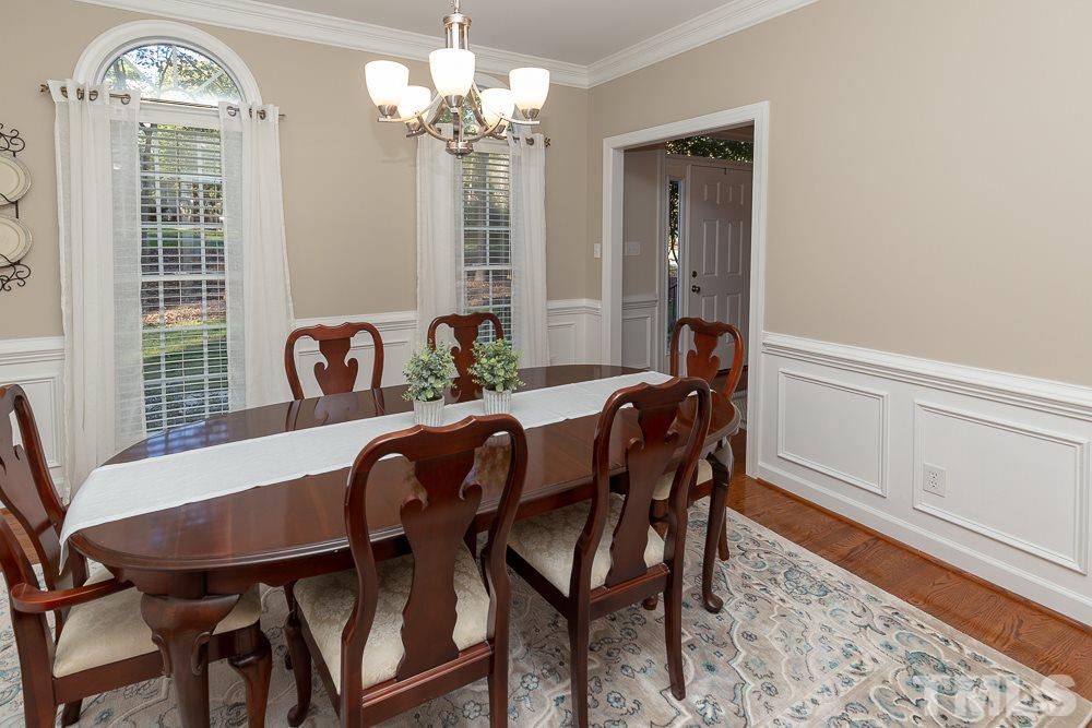 5909 North Hawthorne Way Raleigh, NC 27613 - Photo 8 of 25 a view of a dining room with furniture and chandelier