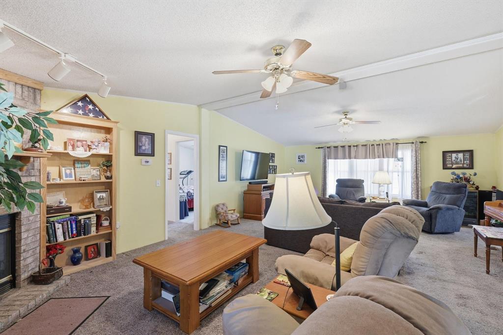 609 Cedar Mills Road Gordonville, TX 76245 - Photo 11 of 38 a living room with furniture a bookshelf and a window