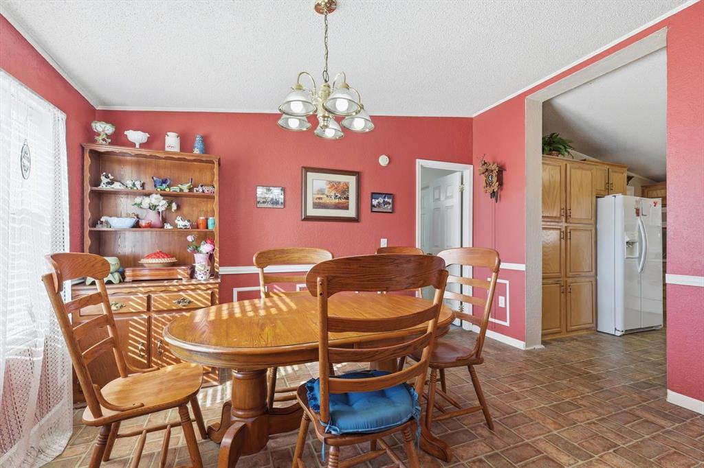 609 Cedar Mills Road Gordonville, TX 76245 - Photo 12 of 38 a dining room with furniture and chandelier
