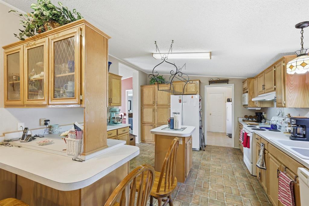 609 Cedar Mills Road Gordonville, TX 76245 - Photo 13 of 38 a kitchen that has a sink and a stove