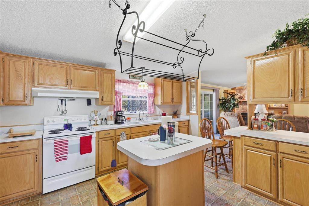 609 Cedar Mills Road Gordonville, TX 76245 - Photo 14 of 38 a kitchen with a sink and cabinets