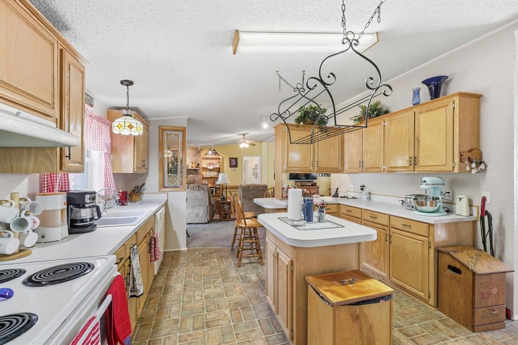 609 Cedar Mills Road Gordonville, TX 76245 - Photo 16 of 38 a very nice looking open kitchen with a dining table and chairs