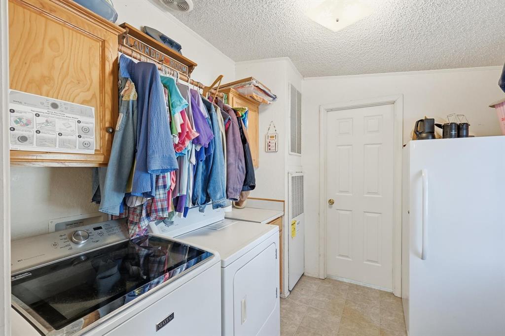 609 Cedar Mills Road Gordonville, TX 76245 - Photo 17 of 38 a view of walk in closet with clothes and shoes