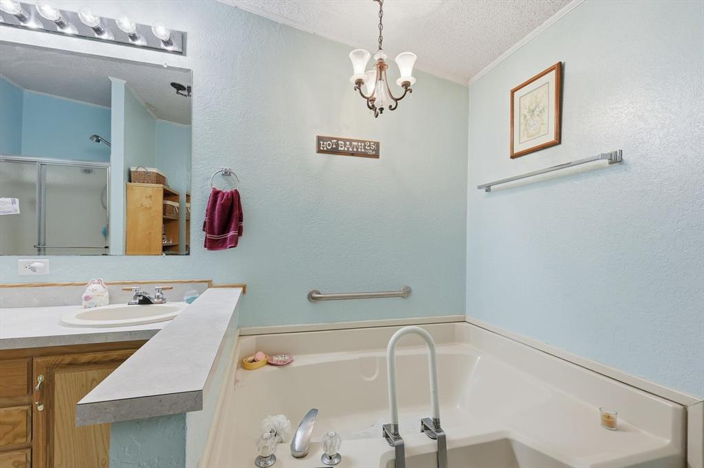 609 Cedar Mills Road Gordonville, TX 76245 - Photo 22 of 38 a bathroom with a sink and a mirror