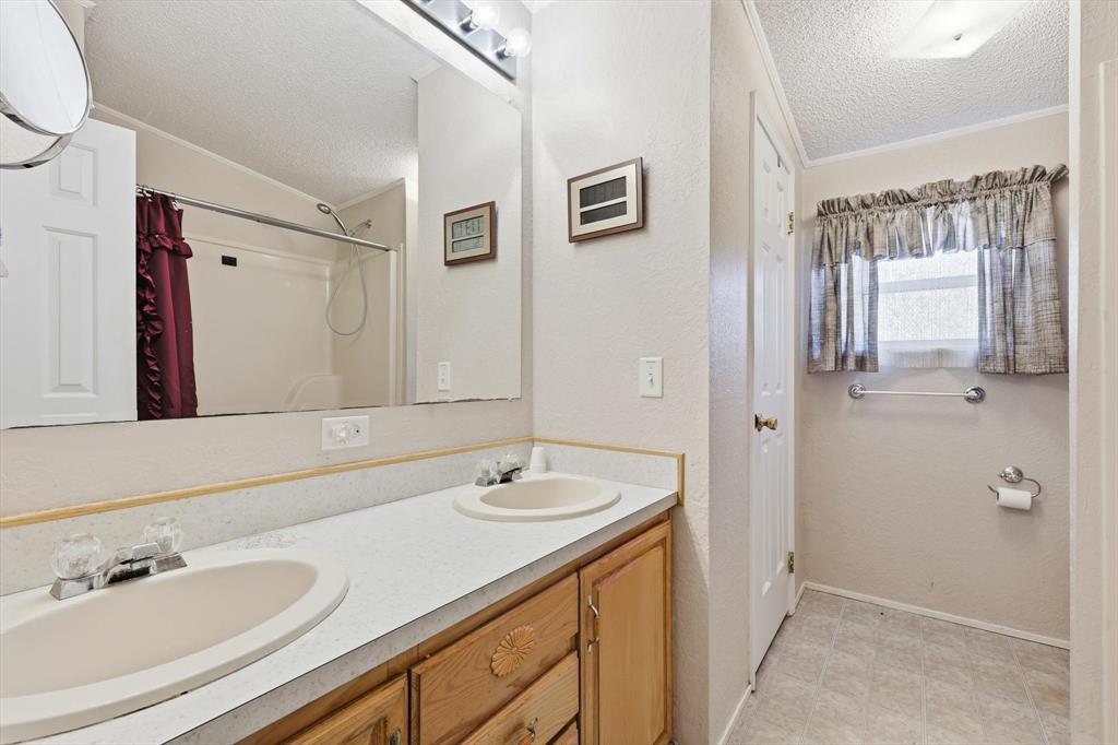 609 Cedar Mills Road Gordonville, TX 76245 - Photo 25 of 38 a bathroom with a sink and a mirror