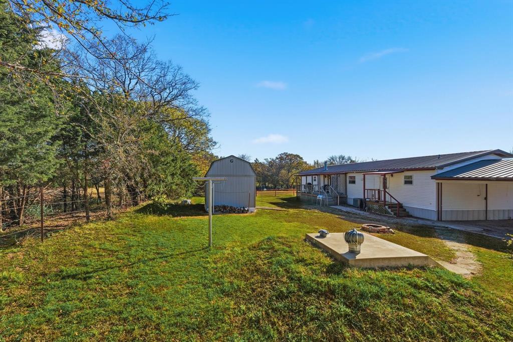 609 Cedar Mills Road Gordonville, TX 76245 - Photo 32 of 38 a view of a swimming pool with a yard and wooden fence
