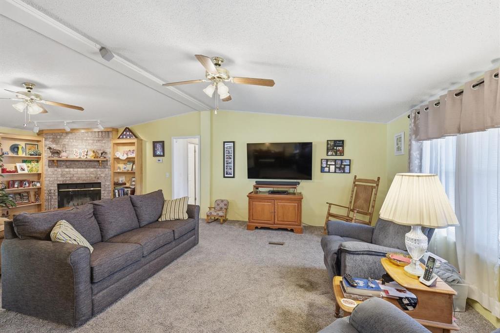 609 Cedar Mills Road Gordonville, TX 76245 - Photo 5 of 38 a living room with furniture kitchen view and a flat screen tv