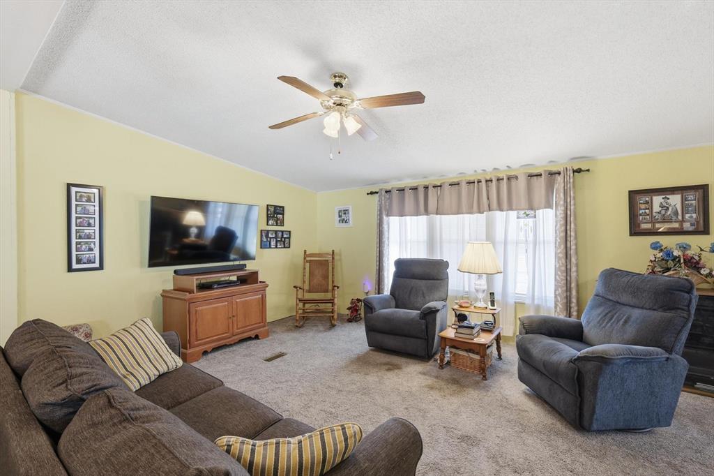 609 Cedar Mills Road Gordonville, TX 76245 - Photo 6 of 38 a living room with furniture and a flat screen tv