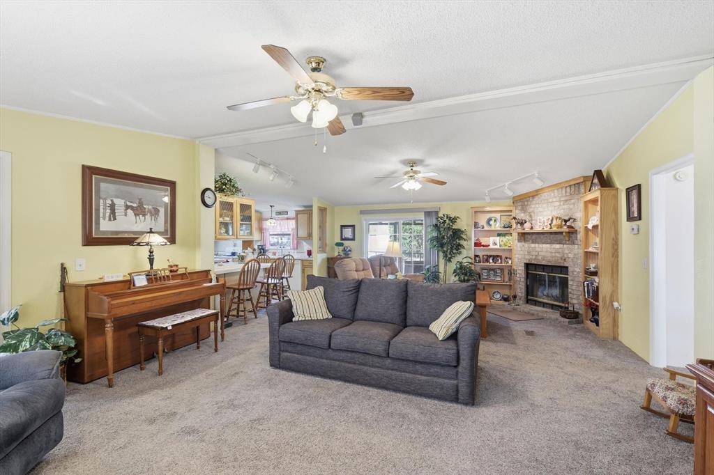 609 Cedar Mills Road Gordonville, TX 76245 - Photo 7 of 38 a living room with furniture kitchen view and a fireplace