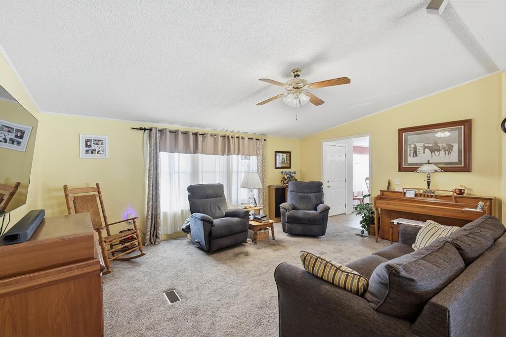 609 Cedar Mills Road Gordonville, TX 76245 - Photo 8 of 38 a living room with furniture a couch and a chandelier