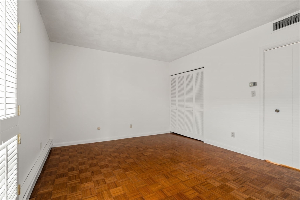 75 Grove Street, Unit 227 Wellesley, MA 02482 - Photo 21 of 29 an empty room with a natural light