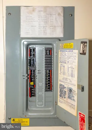 a large white room with wooden floor and furniture