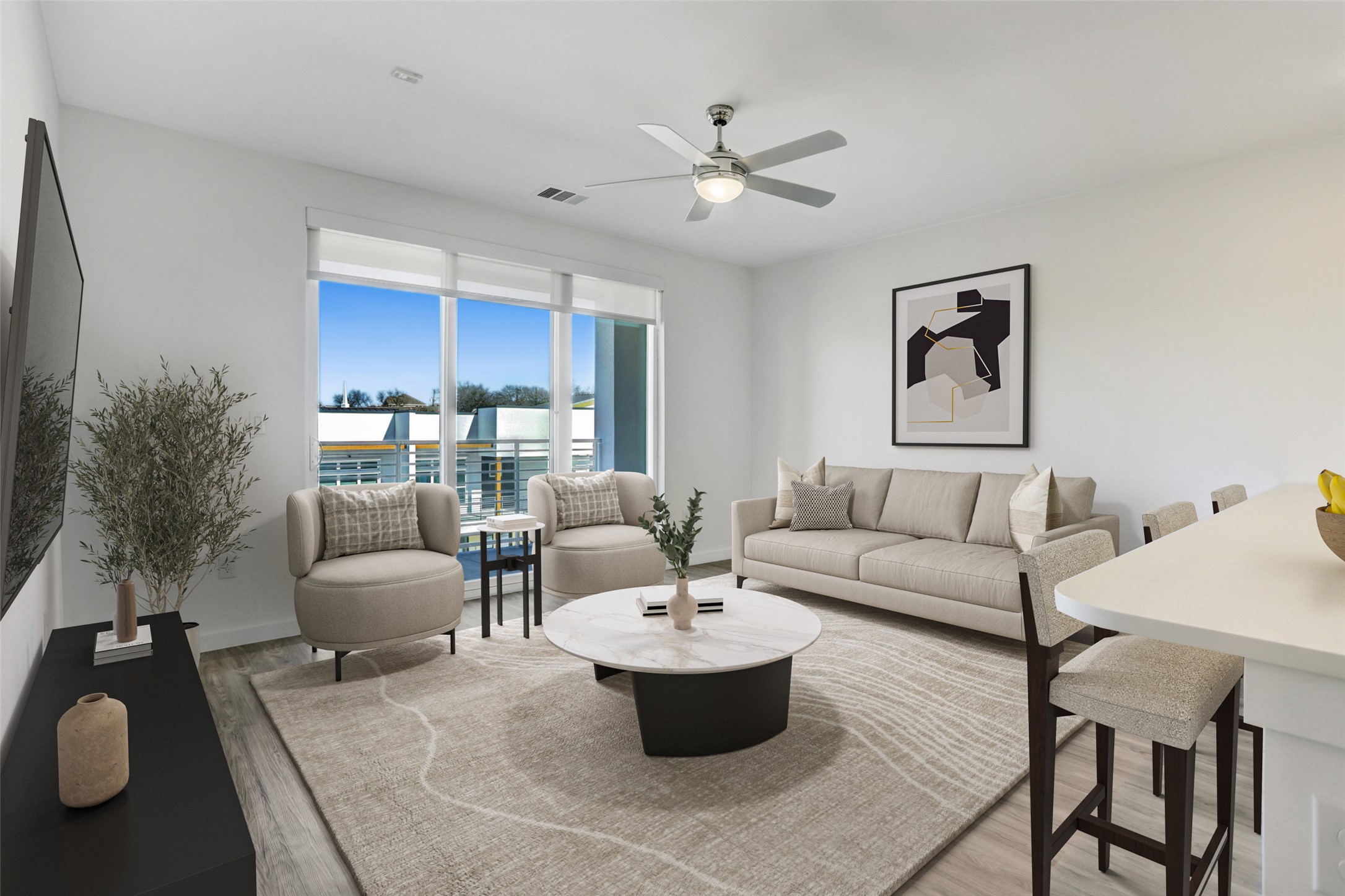 4801 Springdale Road, Unit 2309 Austin, TX 78723 - Photo 2 of 15 The open main living room offers a warm, comfortable space to unwind on the couch or gather with friends, seamlessly connecting to the kitchen and balcony