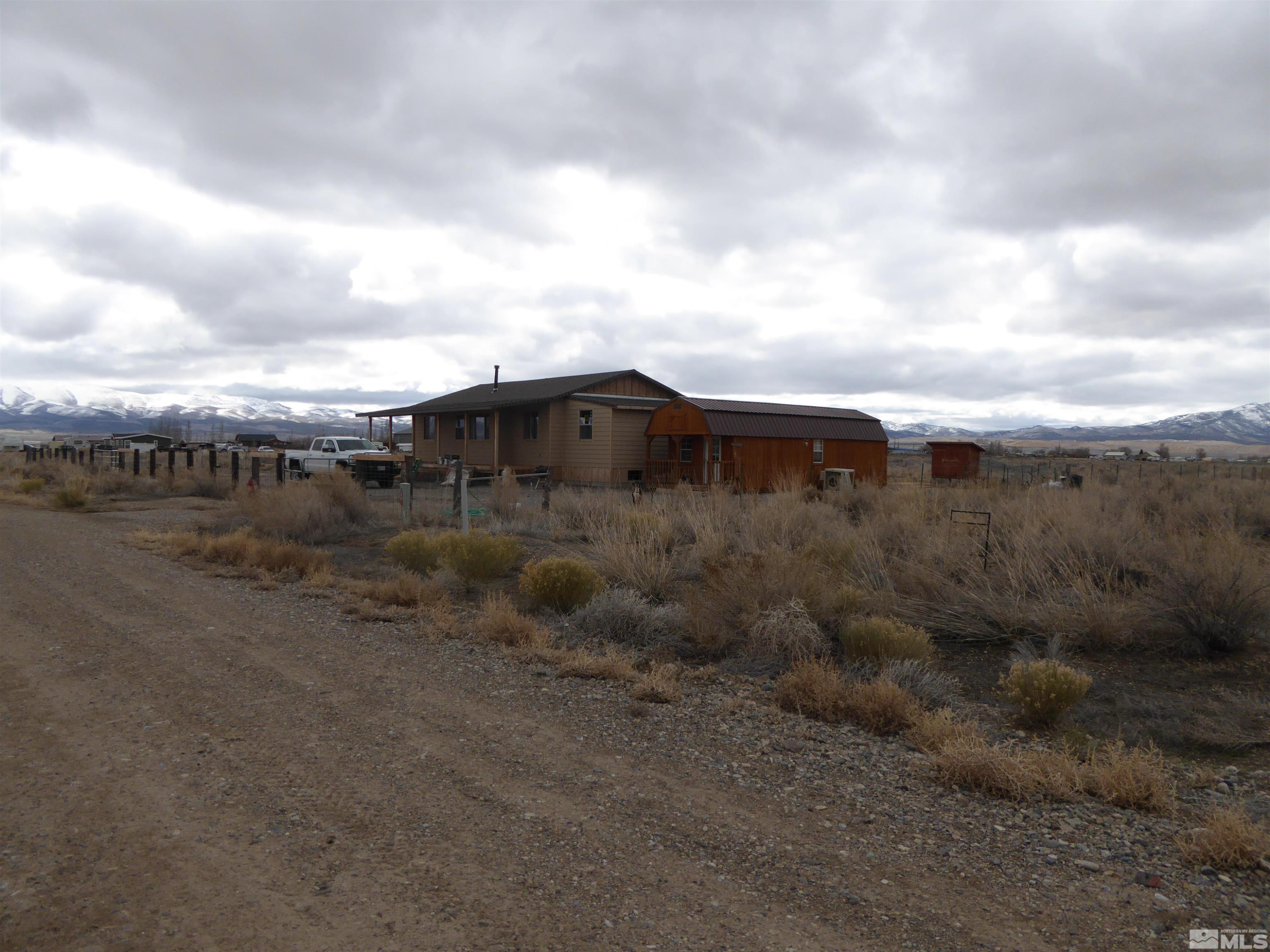 551 El Rancho Street, Unit 4 E47 Eureka, NV 89316 - Photo 4 of 6 a view of a dry yard with wooden fence
